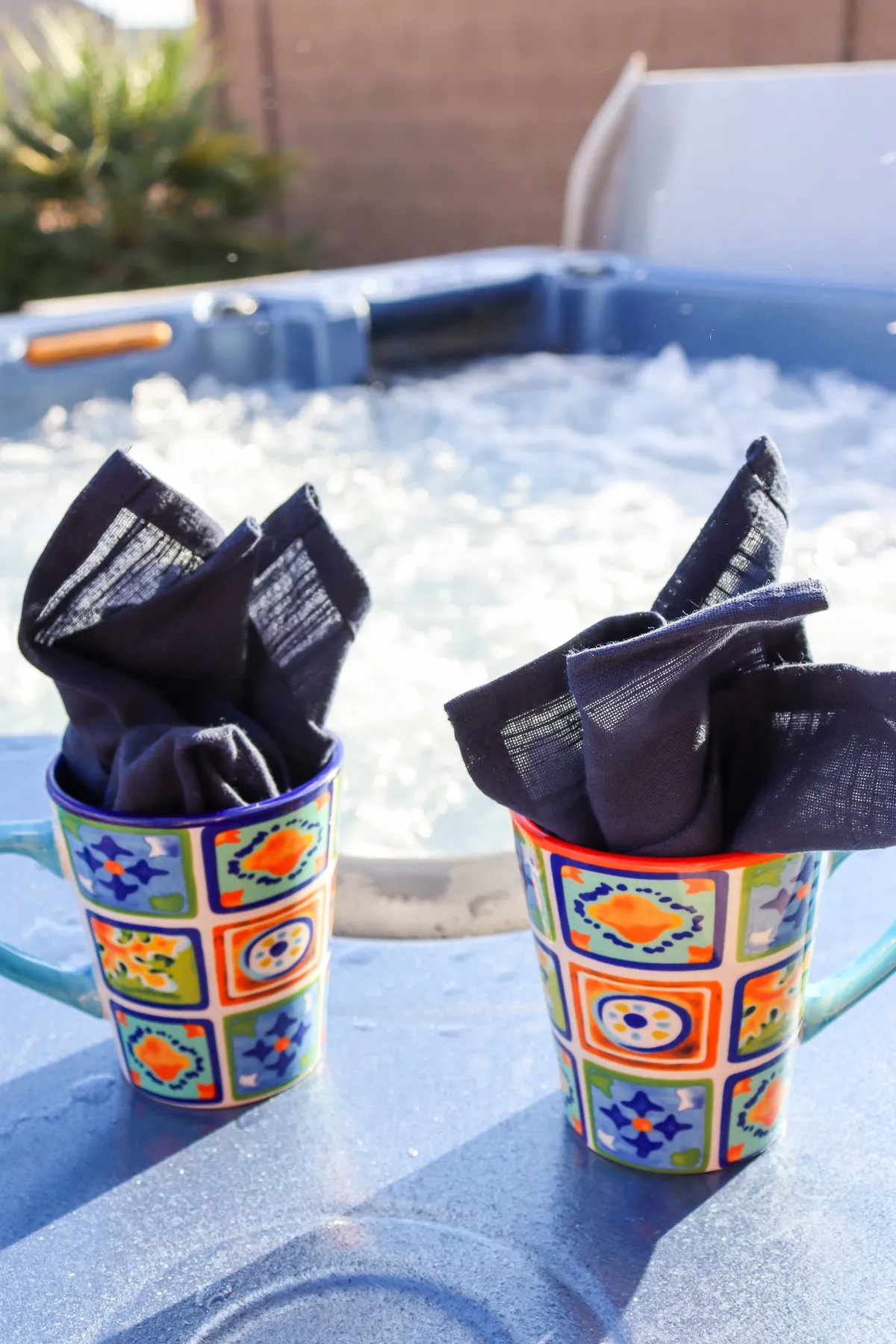A cozy outdoor hot tub setup with colorful mugs and napkins, inviting guests to relax, socialize, and enjoy drinks together. The scene radiates warmth and togetherness, ideal for winding down after a day of family adventures.